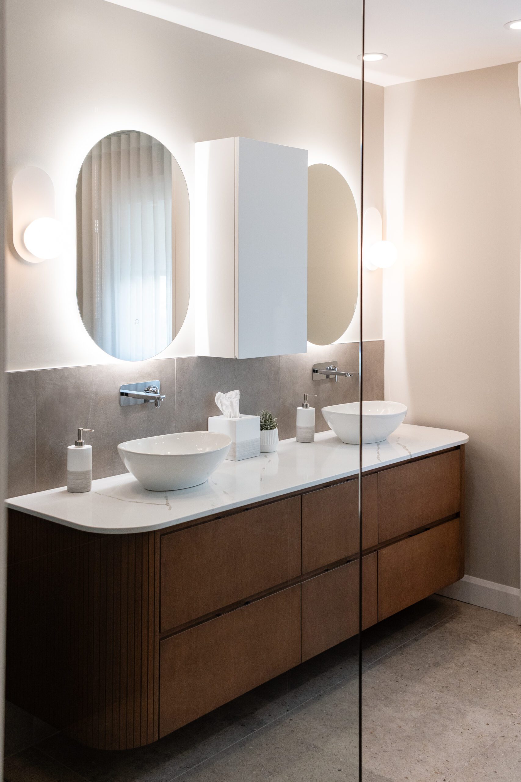 salle de bain moderne teintes de bois et miroir ovale